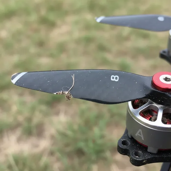 A close-up image showing a damaged, bent, or incorrectly installed drone propeller.