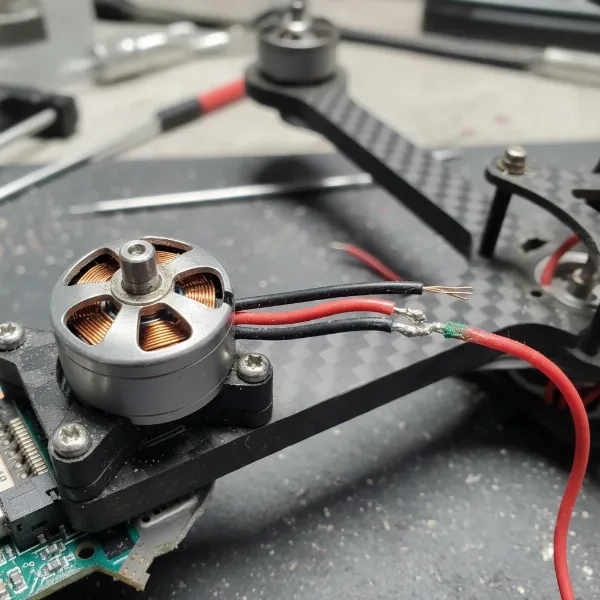 A close-up view of a drone's motor and ESC area, highlighting potential issues or for inspection.